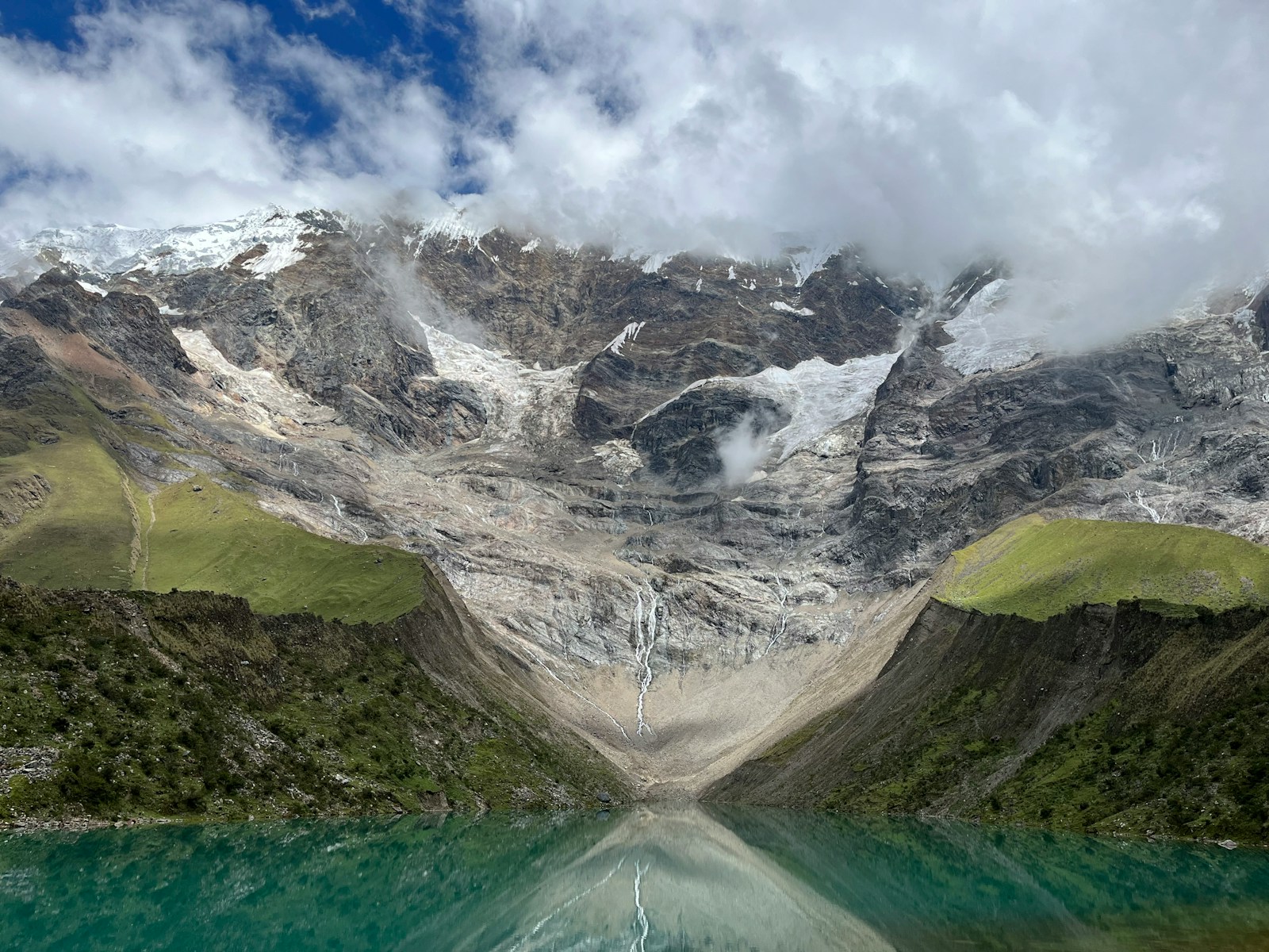 a mountain range with a lake in the foreground