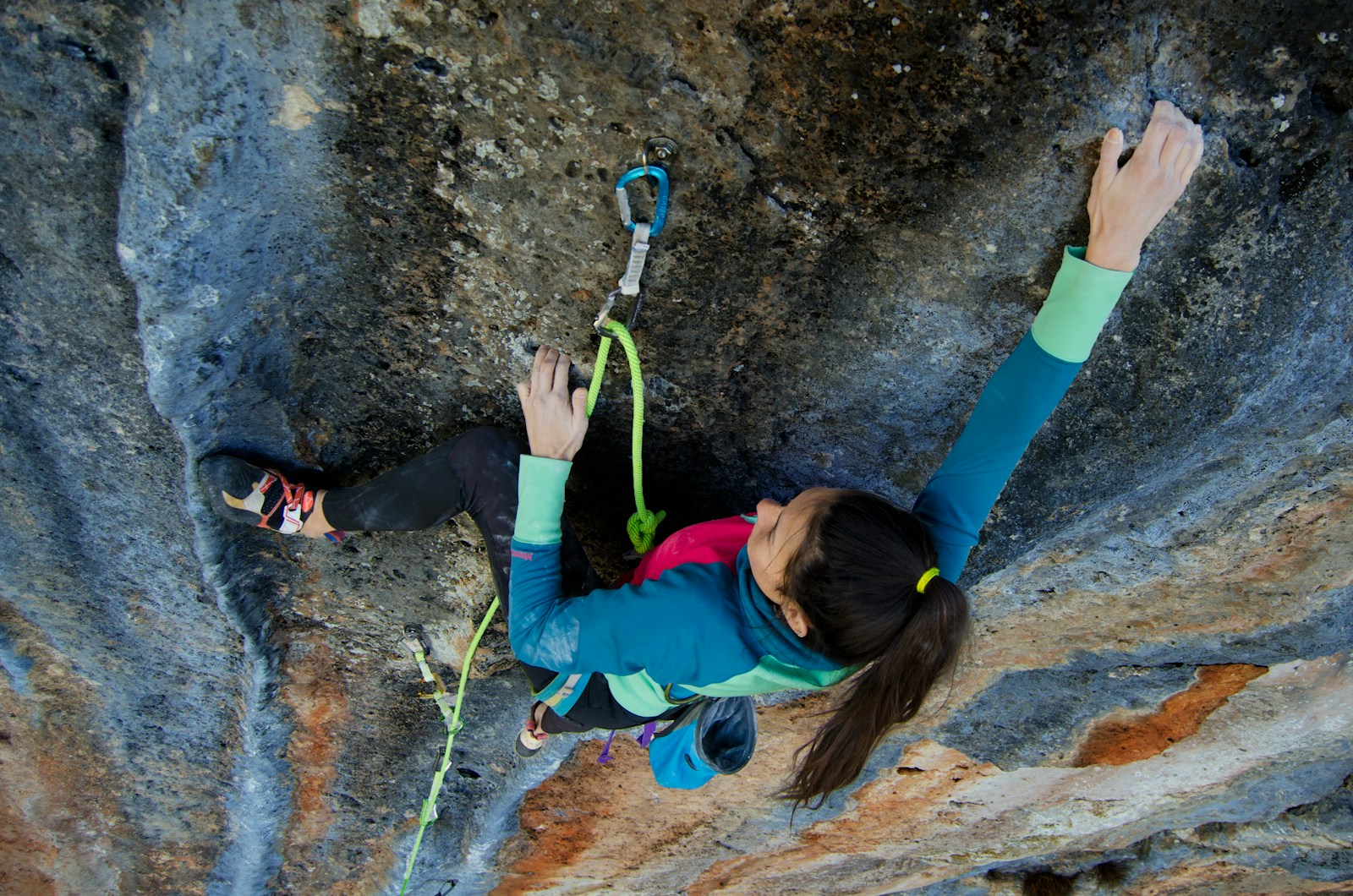 woman climbing on rock